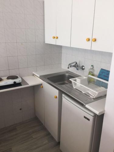 a small kitchen with a sink and a counter at Nautilus Tourist Apartments in Larnaca