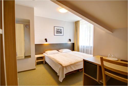 Postel nebo postele na pokoji v ubytování Hotel Jurate