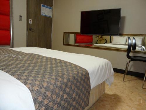 Postel nebo postele na pokoji v ubytování Songdo Blue Hotel