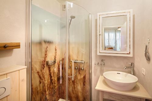 a bathroom with a shower and a sink at Hotel & Restaurant zum Beck in Stansstad