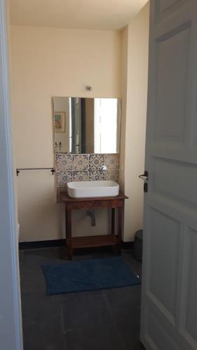a bathroom with a sink and a mirror at Casa Maltese ri Scicli in Scicli
