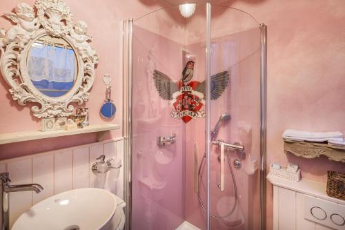 a bathroom with a shower and a toilet and a sink at Hotel & Restaurant zum Beck in Stansstad
