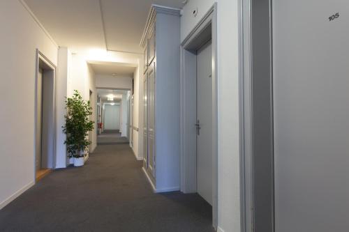 a hallway of an office building with white walls at Hotel Alpha in Luzern