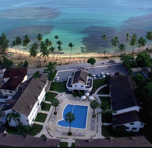an aerial view of a resort with a swimming pool and the ocean at Albachiara Hotel - Las Terrenas in Las Terrenas
