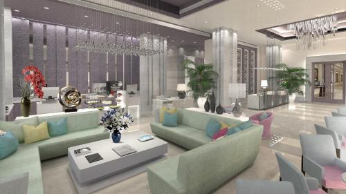 a living room with couches and a table with flowers at Efcee Sarovar Premiere Bhavnagar in Bhavnagar