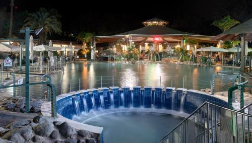 a hot tub at a resort at night at The Camping Site Hamat Gader in Kinneret