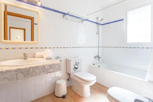 a bathroom with a toilet and a sink and a tub at Monte Azul in Jávea