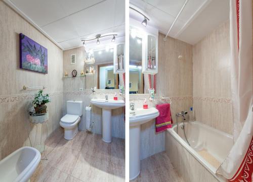 a bathroom with two sinks and a tub and a toilet at Apartment Patacona Beach 6 in Valencia