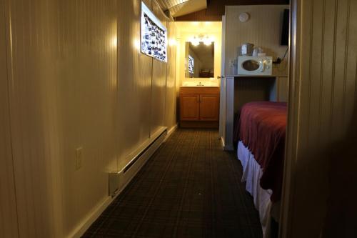 a hallway of a hotel room with a bed at Red Caboose Motel & Restaurant in Ronks