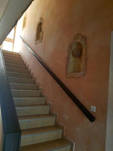 a stairway with stairs with a statue on the wall at Residence Tafat in Agadir
