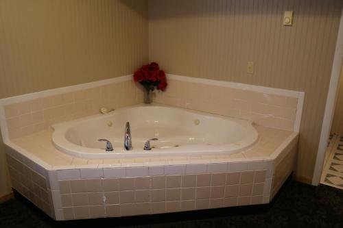 a bath tub with a vase of flowers in it at Red Caboose Motel & Restaurant in Ronks