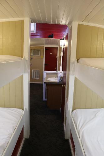 a small room with two beds and a sink at Red Caboose Motel & Restaurant in Ronks