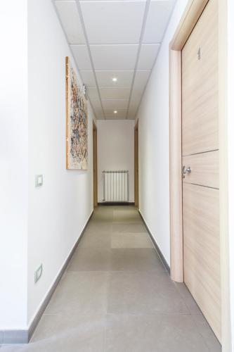 an empty corridor with a door and a painting on the wall at B&B Villa Seta in Agrigento