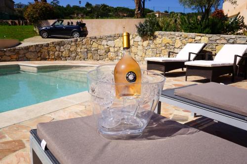 a bottle of wine in a glass sitting on a table at Lone Star House in Sainte-Maxime