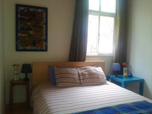 a bedroom with a bed with two tables and a window at Casas Botelho Elias in Pinhão