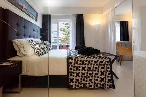En eller flere senge i et værelse på Faro Boutique Hotel