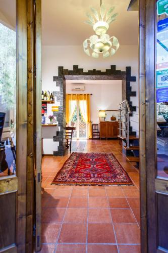 a living room with a tile floor and a chandelier at B&B Villa Seta in Agrigento