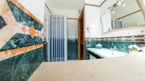 a bathroom with a sink and a mirror at Hotel Al Ritrovo in Piazza Armerina