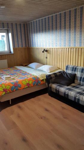 a bedroom with a bed and a couch at Terve Hostel in Pärnu