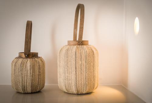 two wicker vases are sitting on a table at San Giorgio in Fira