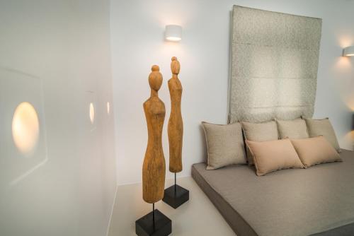 two wooden sculptures in a living room with a couch at San Giorgio in Fira