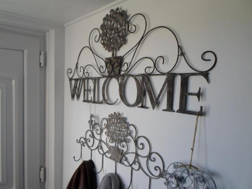 a sign that says whatever hanging on a wall at The Bridges B&B in Broomhill