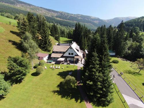 an aerial view of a house in a field with trees at Hotel Resort Martin & Kristyna in Špindlerův Mlýn