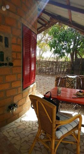 a table and a chair on a patio at Evergreen Eco Lodge Retreat in Tujering