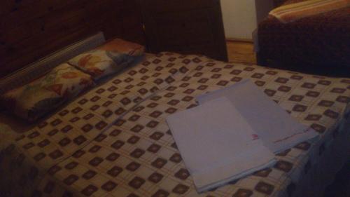 a book sitting on top of a bed at Vecskrīveri in Dundaga