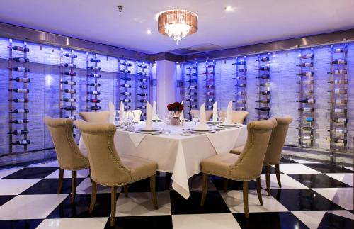 a dining room with a table and chairs and wine cellar at Occidental Punta Cana - All Inclusive in Punta Cana