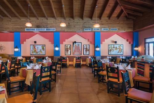 a dining room with tables and chairs and colorful walls at Occidental Punta Cana - All Inclusive in Punta Cana