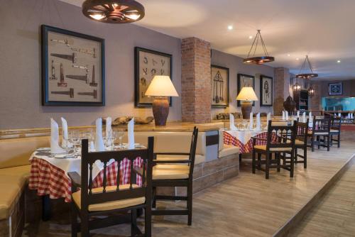 a dining room with tables and chairs in a restaurant at Occidental Punta Cana - All Inclusive in Punta Cana