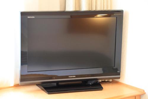 a flat screen tv sitting on top of a table at Richmond Hotel Sapporo Ekimae in Sapporo