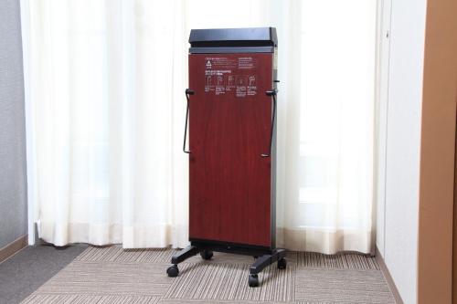 a red refrigerator sitting in front of a window at Richmond Hotel Sapporo Ekimae in Sapporo