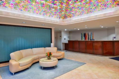 a lobby with a waiting room with a couch and a table at Best Western PLUS La Mesa San Diego in La Mesa