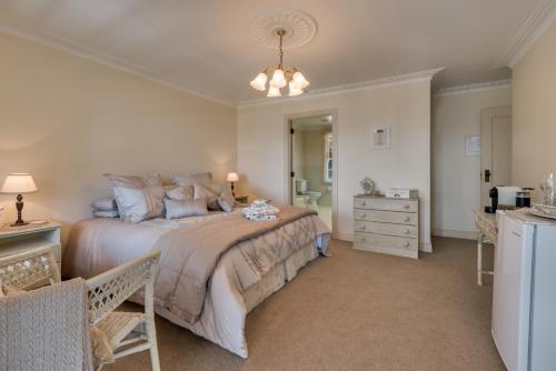 a bedroom with a large bed and a bathroom at Bellevue Boutique Lodge in Taupo