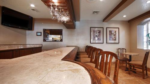 a bar with chairs and a large wooden table at Best Western San Dimas Hotel & Suites in San Dimas