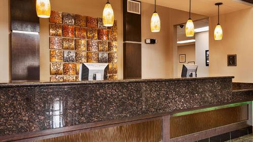 a bar in a restaurant with pendant lights at Best Western Inn & Suites - Lake Charles in Lake Charles