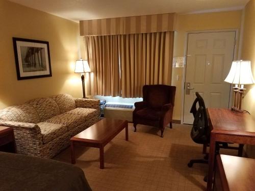a living room with a couch and a chair in a hotel room at Best Western Salbasgeon Inn & Suites in Reedsport