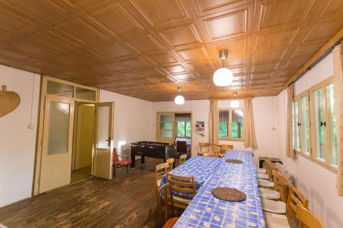 a room with two long tables and chairs and a piano at Cyklochata in Vranov nad Dyjí