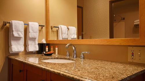 a bathroom counter with a sink and a mirror at Best Western Inn at the Rogue in Rogue River