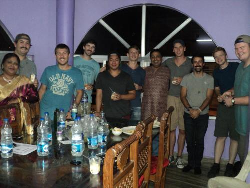 a group of people posing for a picture at a table at Royal Paying Guest in Kolkata
