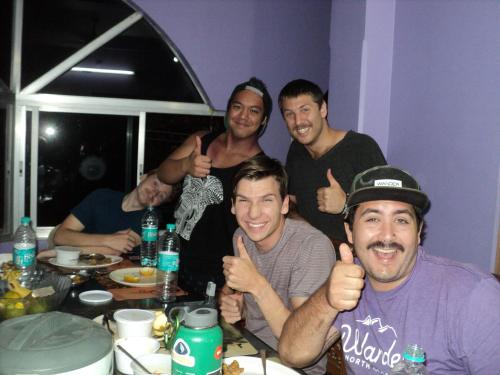a group of men giving thumbs up at a table at Royal Paying Guest in Kolkata