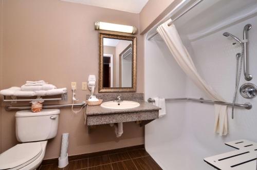 a bathroom with a toilet and a sink and a shower at Best Western Dayton Inn & Suites in Dayton
