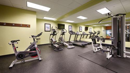 a gym with several tread machines in a room at Best Western Plus Layton Park Hotel in Layton
