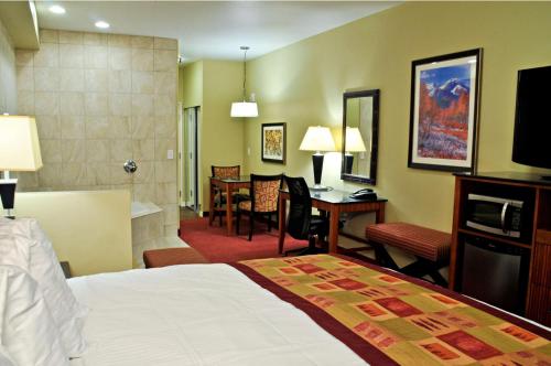 a hotel room with a bed and a desk at Best Western Plus Layton Park Hotel in Layton