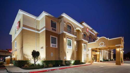 a large hotel building at night at Best Western Plus Katy Inn & Suites in Katy