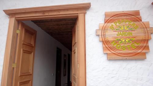 a sign on the side of a building with a door at Sergeant Pepper's Hostel in Jardin