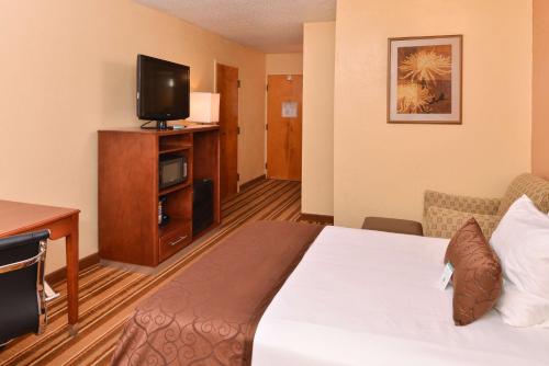 a hotel room with a bed and a flat screen tv at Best Western Plus Richmond in Sandston
