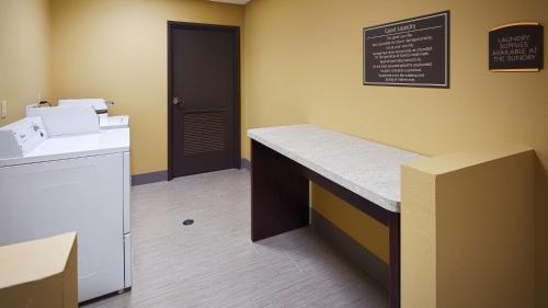 a kitchen with a counter and a chalkboard on the wall at Best Western Plus New Orleans Airport Hotel in Kenner